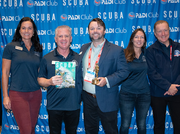 Cole Watkins at Readers' Choice Awards receiving award for Scuba Diving Magazine